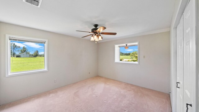 empty room featuring light carpet and ceiling fan