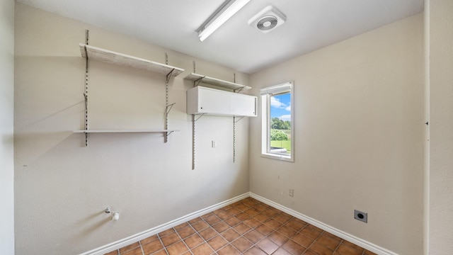 laundry area featuring tile patterned floors and hookup for an electric dryer