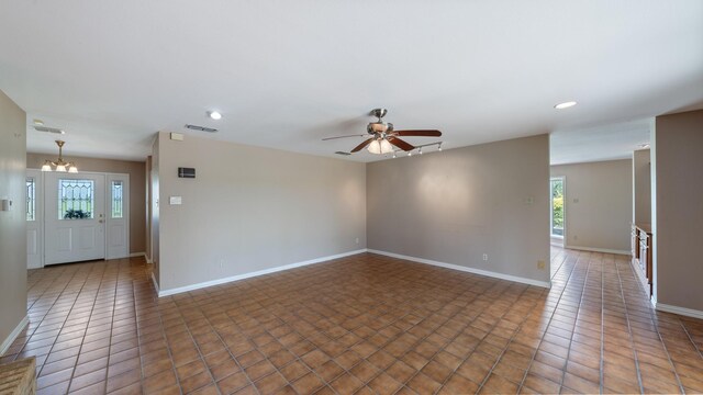 unfurnished living room featuring a brick fireplace, light tile flooring, wood walls, ceiling fan, and built in shelves