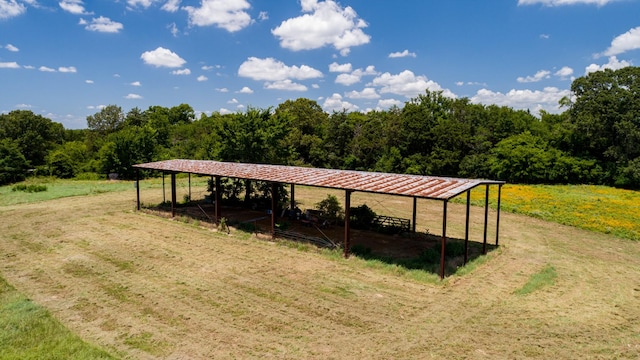 view of home's community with a rural view and a yard