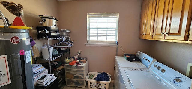 washroom featuring cabinets, washing machine and dryer, and water heater