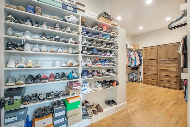 spacious closet with light hardwood / wood-style flooring