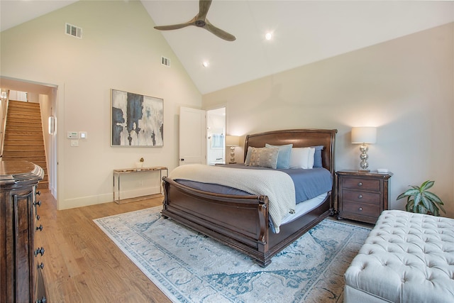 bedroom with light hardwood / wood-style flooring, high vaulted ceiling, and ceiling fan