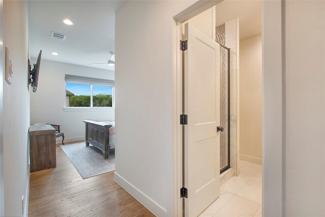 bathroom featuring tile patterned flooring, vanity, and a shower with door