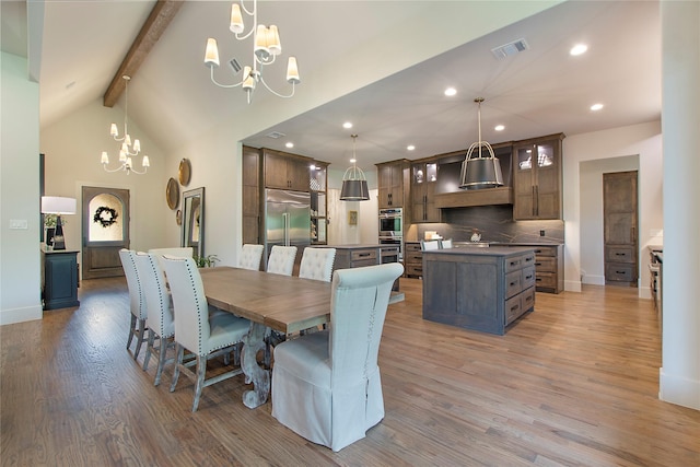 dining area with high vaulted ceiling, beamed ceiling, a chandelier, and light wood-type flooring