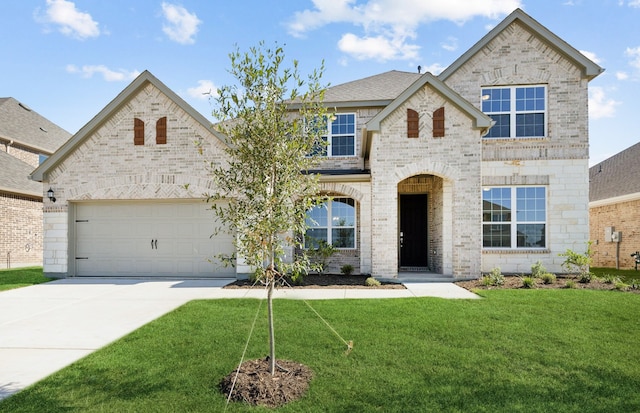 view of front facade with a front yard and a garage