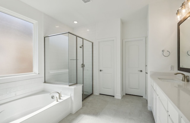 bathroom with a wealth of natural light, vanity, and shower with separate bathtub