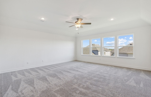 carpeted spare room with ceiling fan