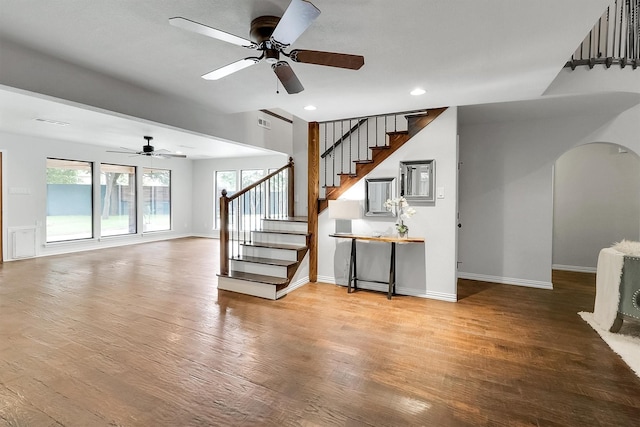 unfurnished living room featuring ceiling fan and wood-type flooring