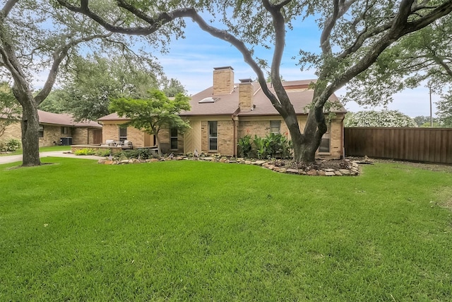 view of front of property featuring central AC and a front lawn