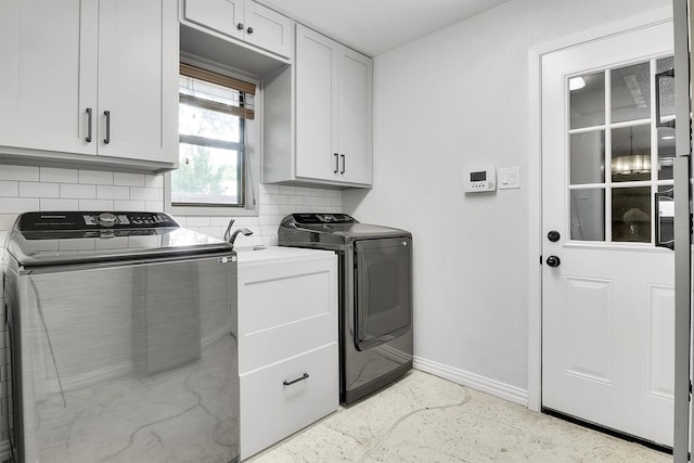 laundry room with cabinets and separate washer and dryer