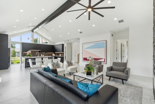 living room featuring beamed ceiling, high vaulted ceiling, ceiling fan, and sink