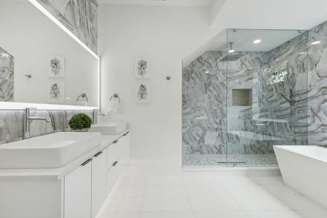 bathroom featuring tile patterned flooring, shower with separate bathtub, and vanity