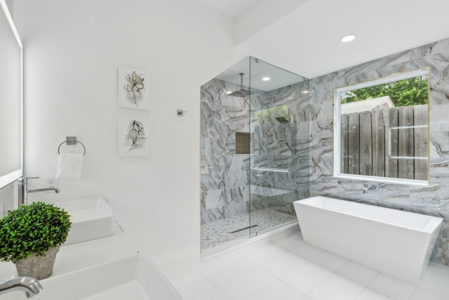 bathroom featuring tile patterned flooring, sink, independent shower and bath, and tile walls