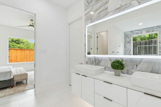 bathroom with tile patterned flooring, vanity, a healthy amount of sunlight, and ceiling fan