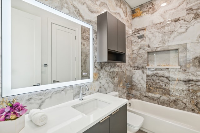 full bathroom featuring vanity, backsplash, shower / washtub combination, toilet, and tile walls