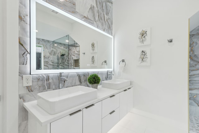 bathroom featuring tile patterned floors, vanity, and a shower with shower door