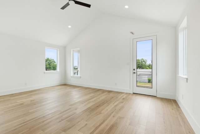 empty room featuring ceiling fan, high vaulted ceiling, and light hardwood / wood-style floors