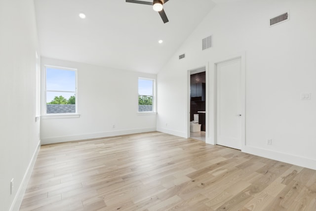 unfurnished room featuring high vaulted ceiling, a healthy amount of sunlight, and light wood-type flooring