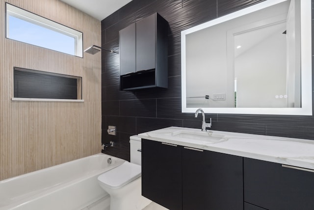 full bathroom featuring vanity, toilet, tile walls, and shower / washtub combination