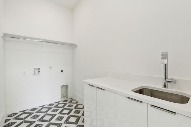 washroom featuring sink, cabinets, and hookup for an electric dryer