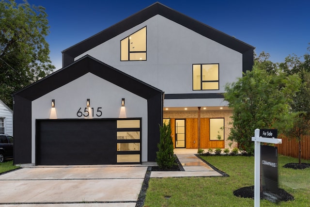 contemporary house with a front yard and a garage