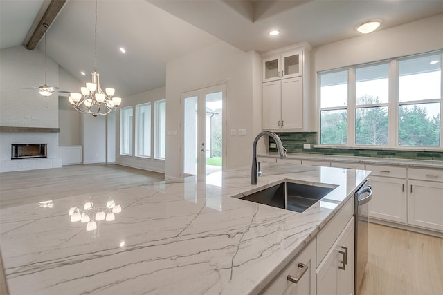 kitchen featuring white cabinets, sink, and light wood-type flooring