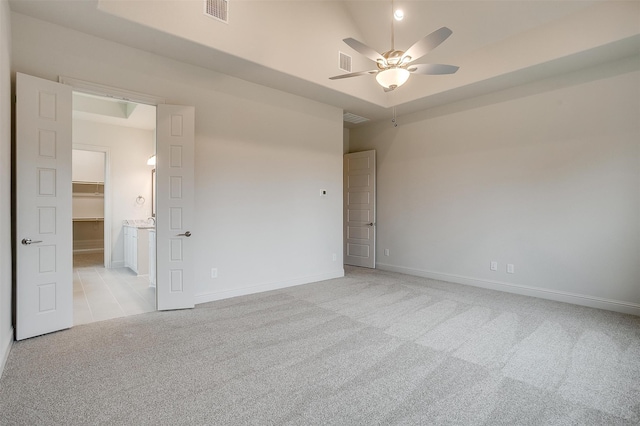 unfurnished room with light colored carpet and ceiling fan