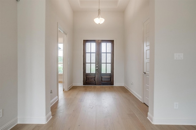 foyer featuring light wood-type flooring and french doors