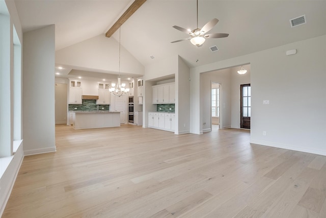 unfurnished living room with beamed ceiling, high vaulted ceiling, light hardwood / wood-style flooring, and ceiling fan with notable chandelier