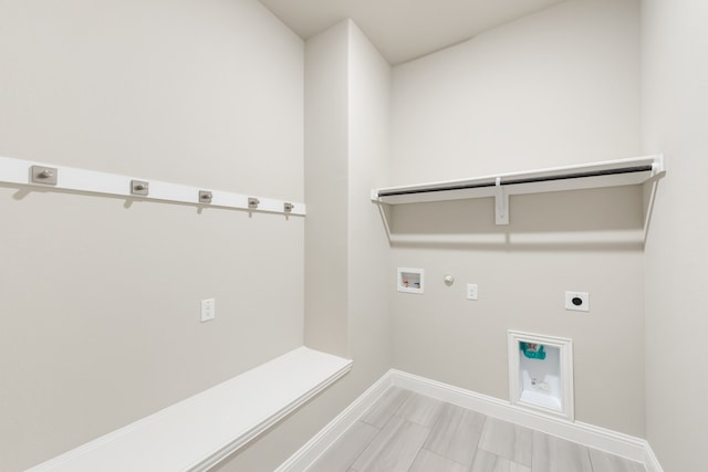 washroom with hookup for a gas dryer, hardwood / wood-style floors, washer hookup, and electric dryer hookup