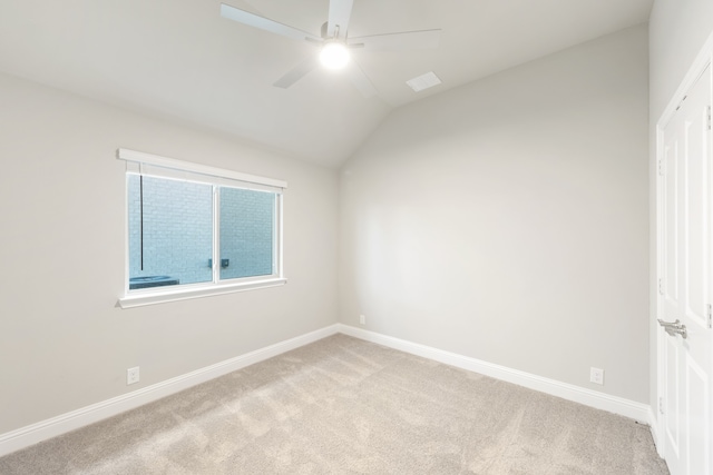 carpeted empty room featuring ceiling fan and vaulted ceiling