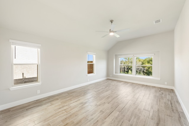 empty room with light hardwood / wood-style flooring, vaulted ceiling, and ceiling fan