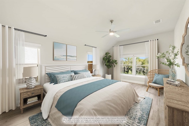 bedroom with light hardwood / wood-style floors, vaulted ceiling, and ceiling fan