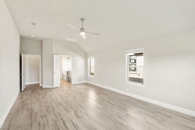 unfurnished bedroom with ceiling fan, lofted ceiling, and light wood-type flooring