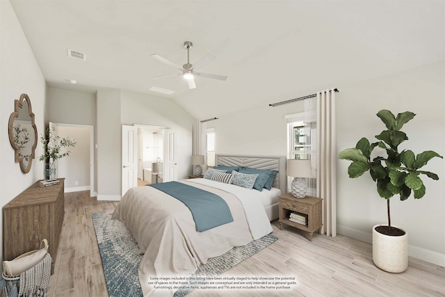 bedroom with ceiling fan, vaulted ceiling, light wood-type flooring, and ensuite bath