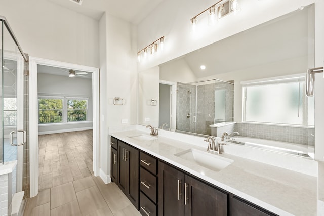 bathroom featuring independent shower and bath, ceiling fan, vaulted ceiling, vanity, and tile patterned flooring