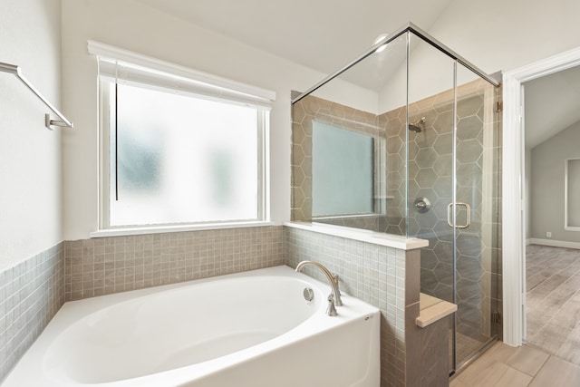 bathroom featuring lofted ceiling, separate shower and tub, and hardwood / wood-style floors