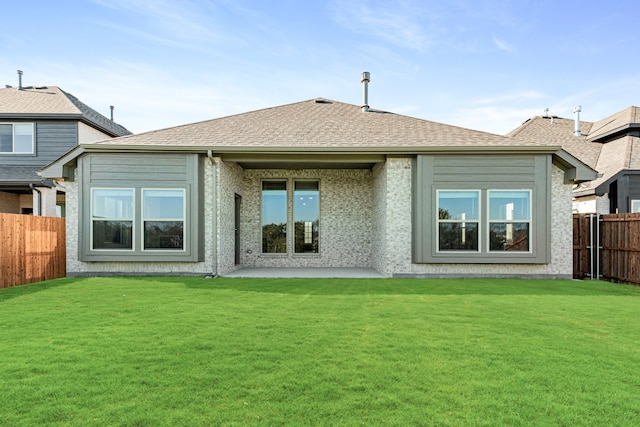 back of house featuring a yard