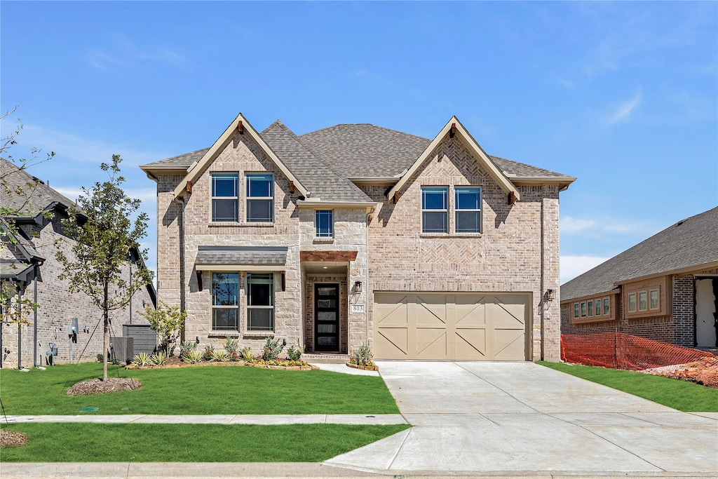 view of front of house with a front yard and a garage