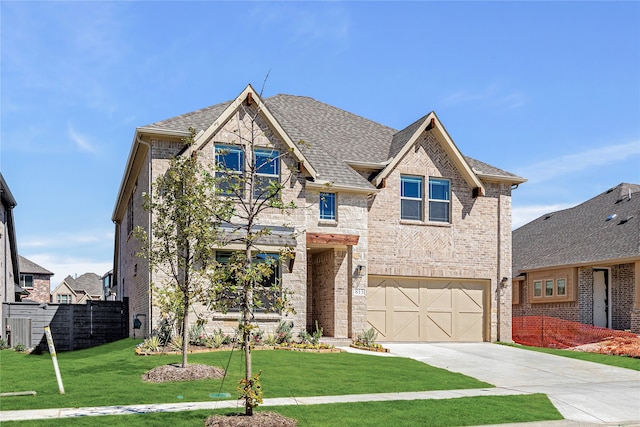 view of front facade featuring a front yard and a garage