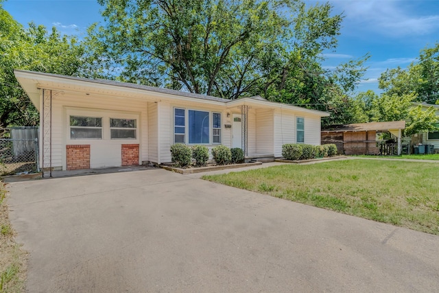 ranch-style home with a garage and a front lawn