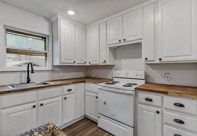 kitchen with white cabinetry, sink, white electric range oven, and butcher block countertops