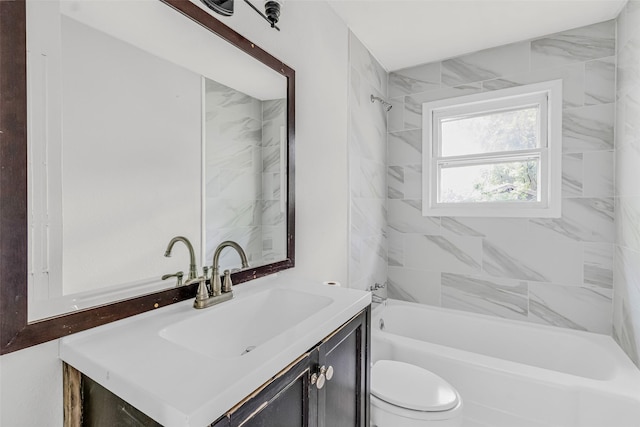 full bathroom with vanity, toilet, and tiled shower / bath