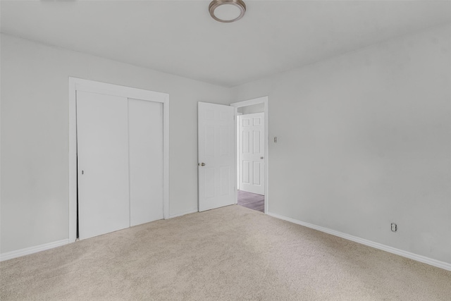 unfurnished bedroom featuring a closet and carpet