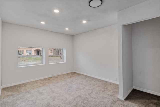 unfurnished room with light carpet