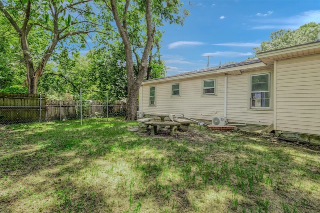 rear view of property featuring a yard