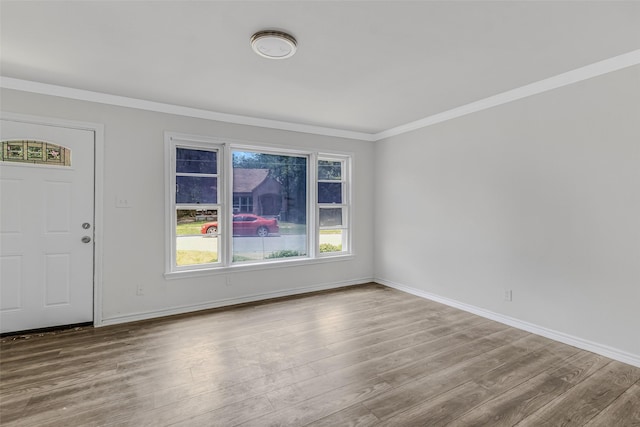 interior space with light hardwood / wood-style flooring and ornamental molding