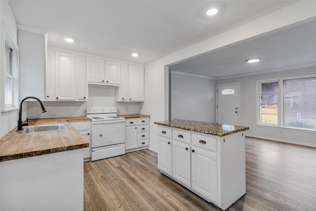 kitchen featuring butcher block counters, sink, white cabinets, white electric range oven, and light hardwood / wood-style flooring