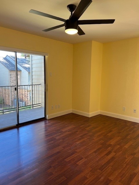 empty room with ceiling fan and dark wood-type flooring